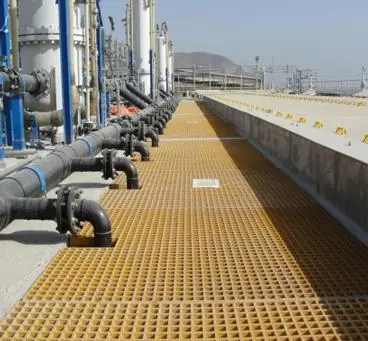 Grating walkway alongside industrial piping
