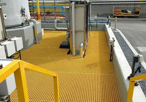 Installed FRP grating platform with handrail near tanks and piping